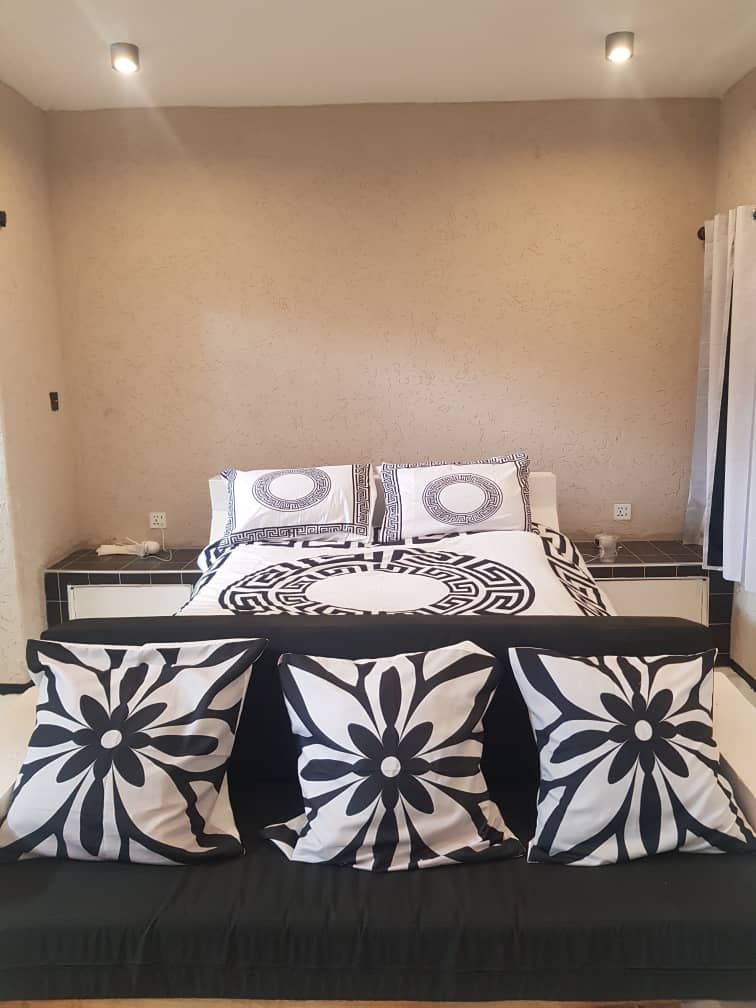 Farai Circle bedroom with monochrome patterned linen
