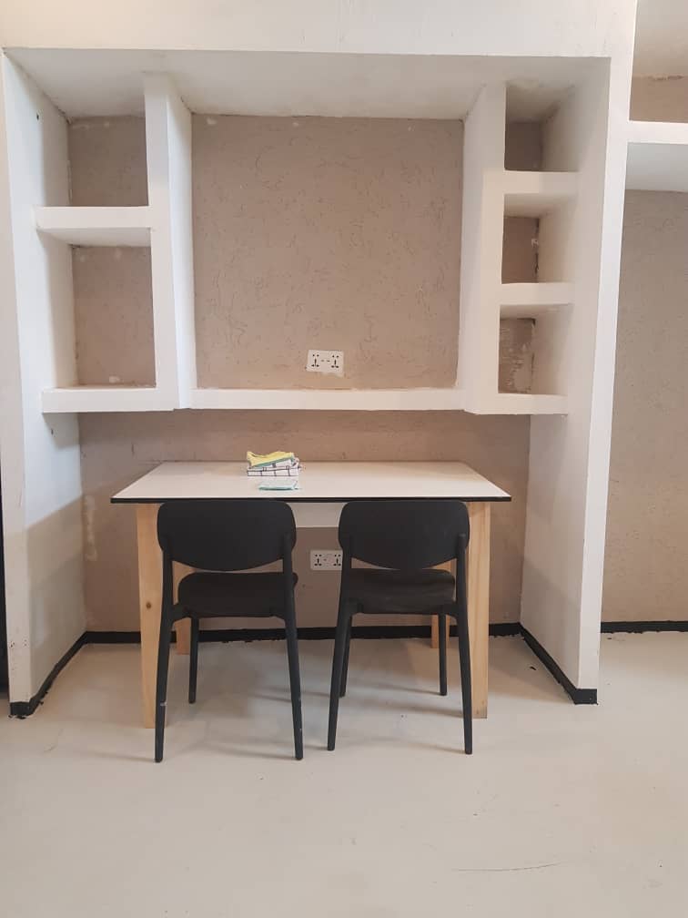Bedroom shelving and work area opening towards the trees